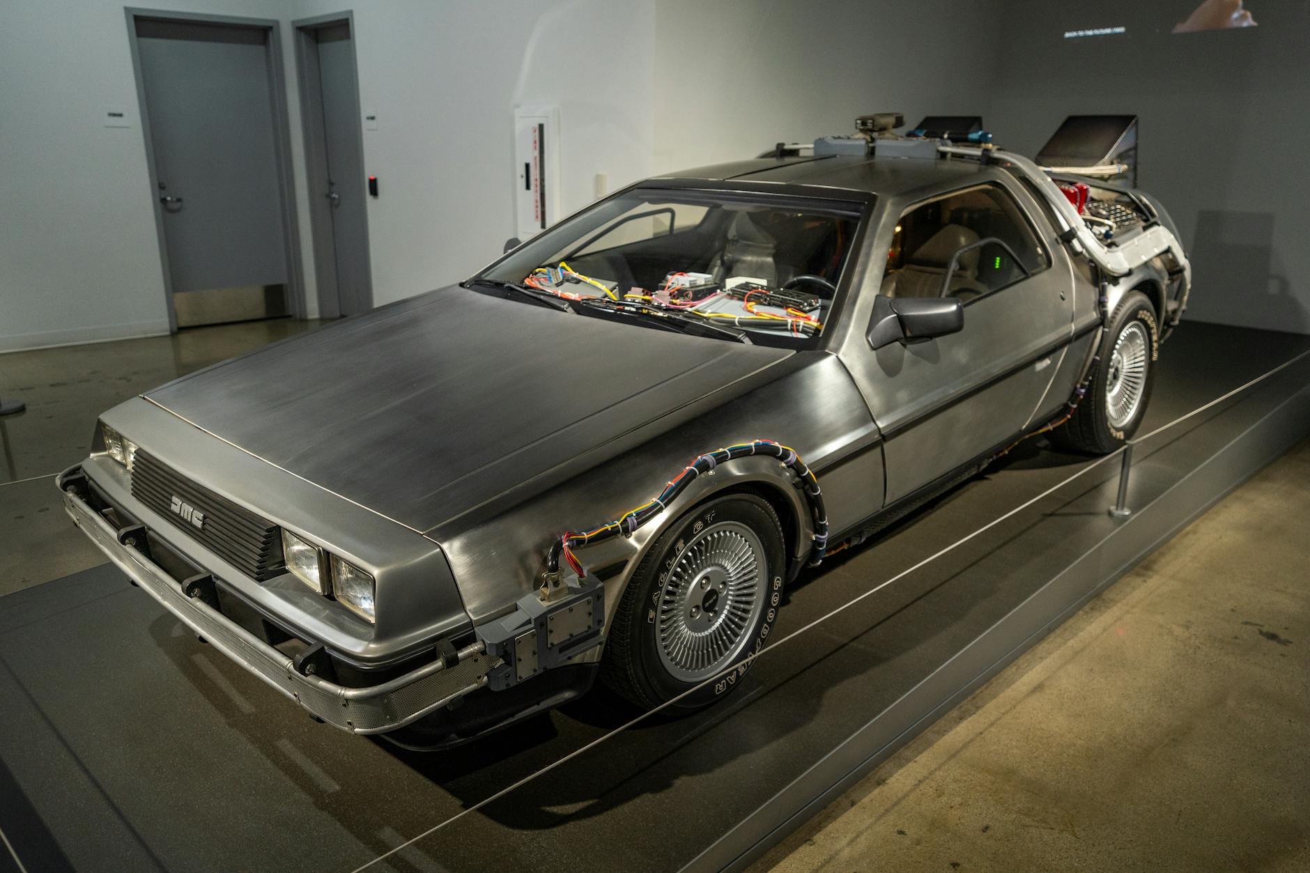 retro delorean car exhibit in museum setting